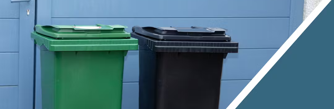 A compost and garbage bin side by side 